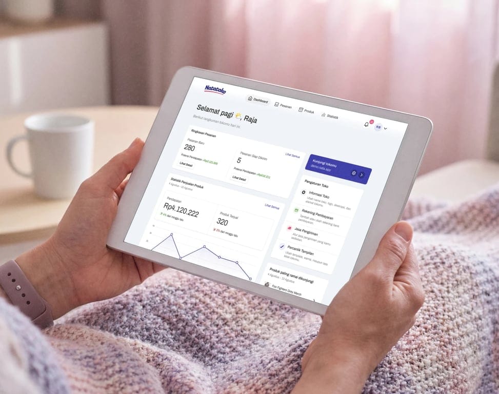 A tablet held in both hands showing a seller dashboard with order summaries, revenue statistics, and line charts for recent sales performance.