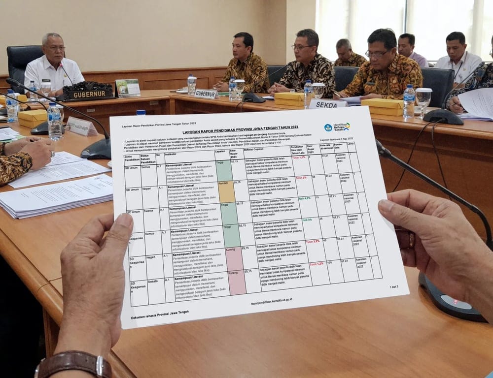 Printed education report held during a government meeting